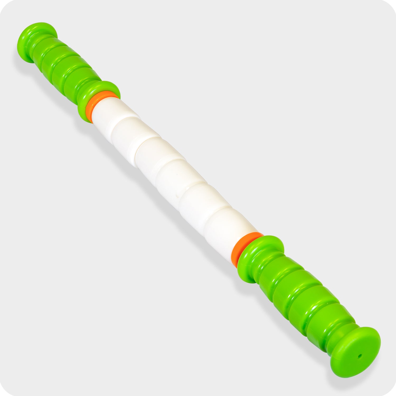The Little Stick-14 is a portable massage tool featuring green ribbed handles, white segmented rollers, and two orange rings—ideal for muscle recovery and trigger point relief.