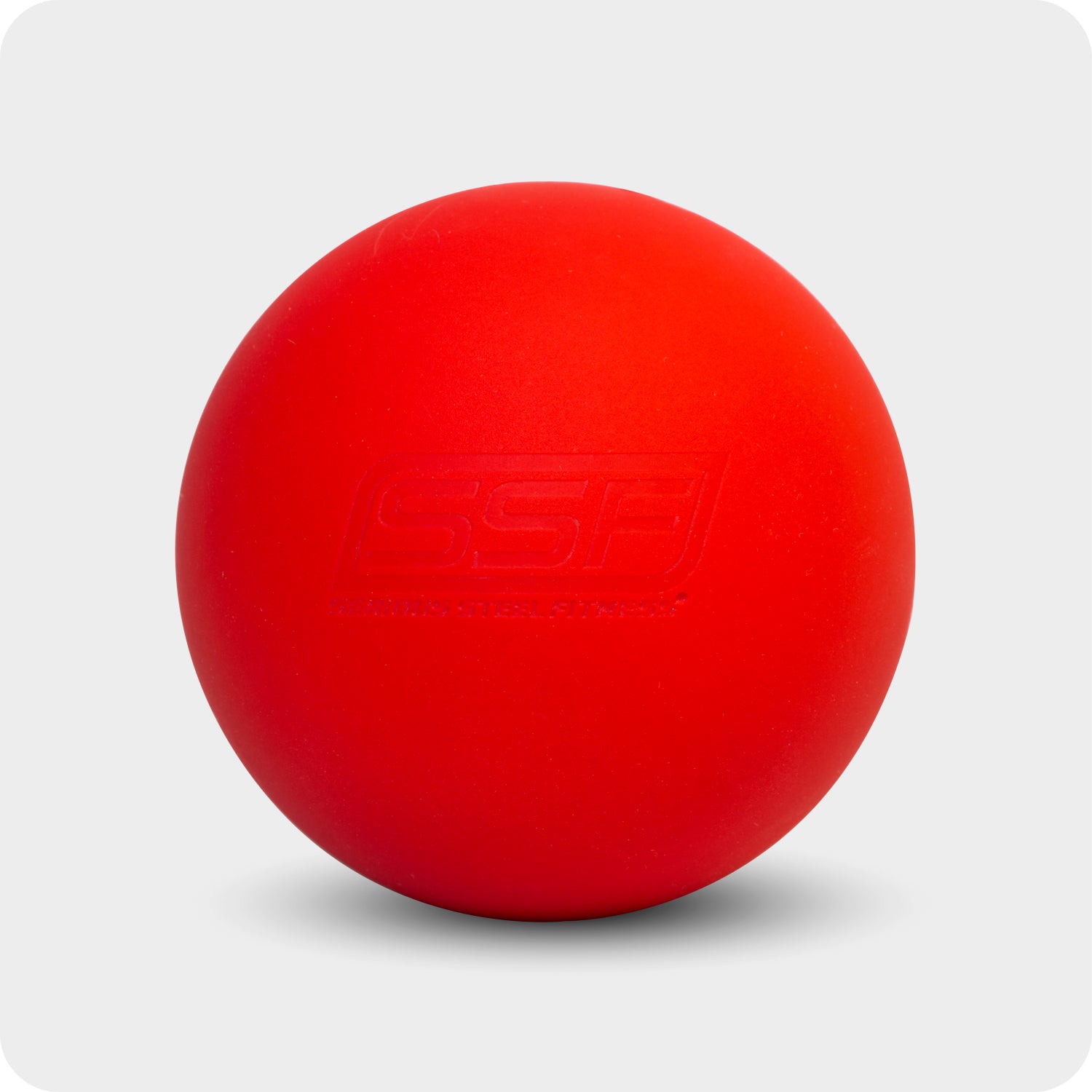 The Lacrosse Ball—a vivid red rubber ball with a subtle embossed logo—rests on a light gray background, making it ideal for mobility and recovery massage.