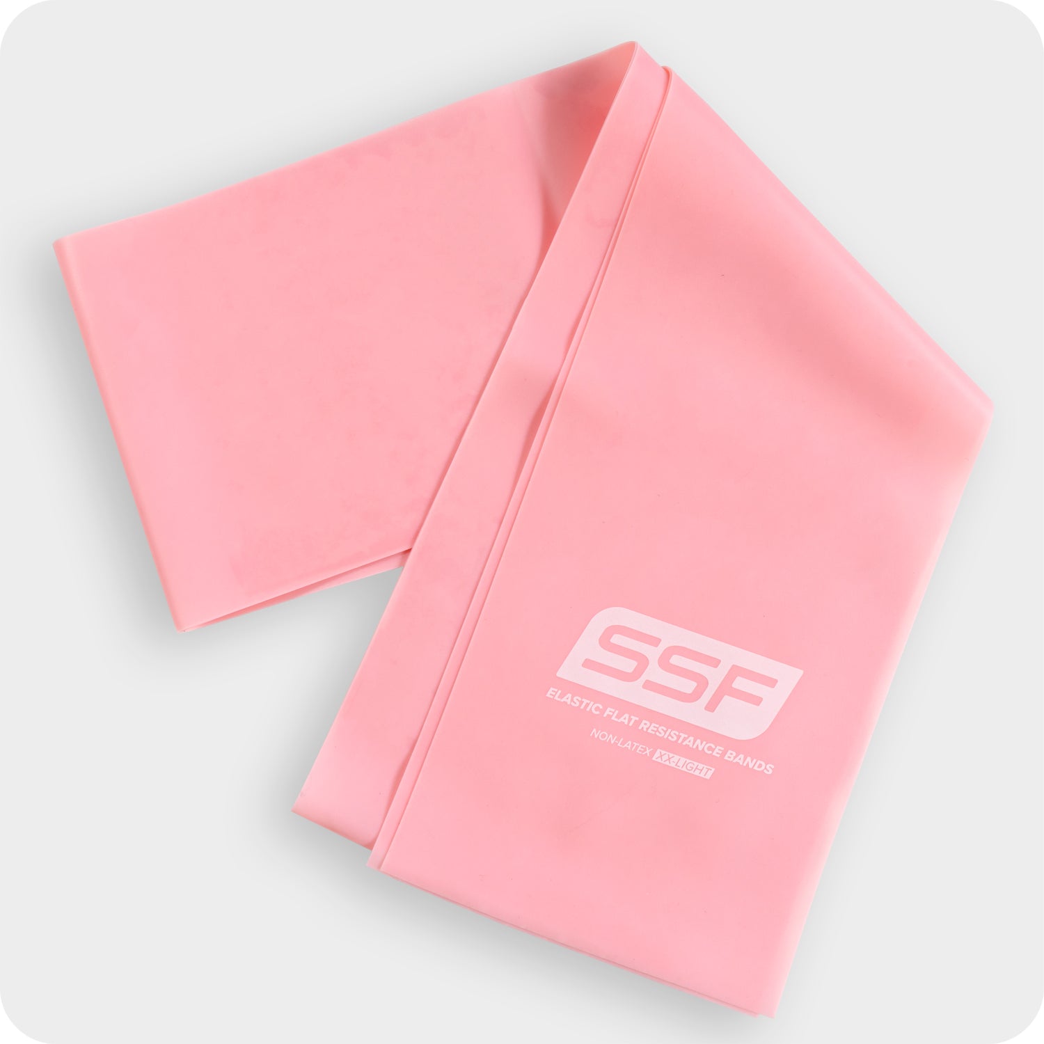 A pink Physical Therapy Exercise Band, 4 x 5, ideal for home workouts and flexibility training, is folded on a light gray background. SSF Elastic Flat Resistance Bands NON-LATEX is printed in white on the band.