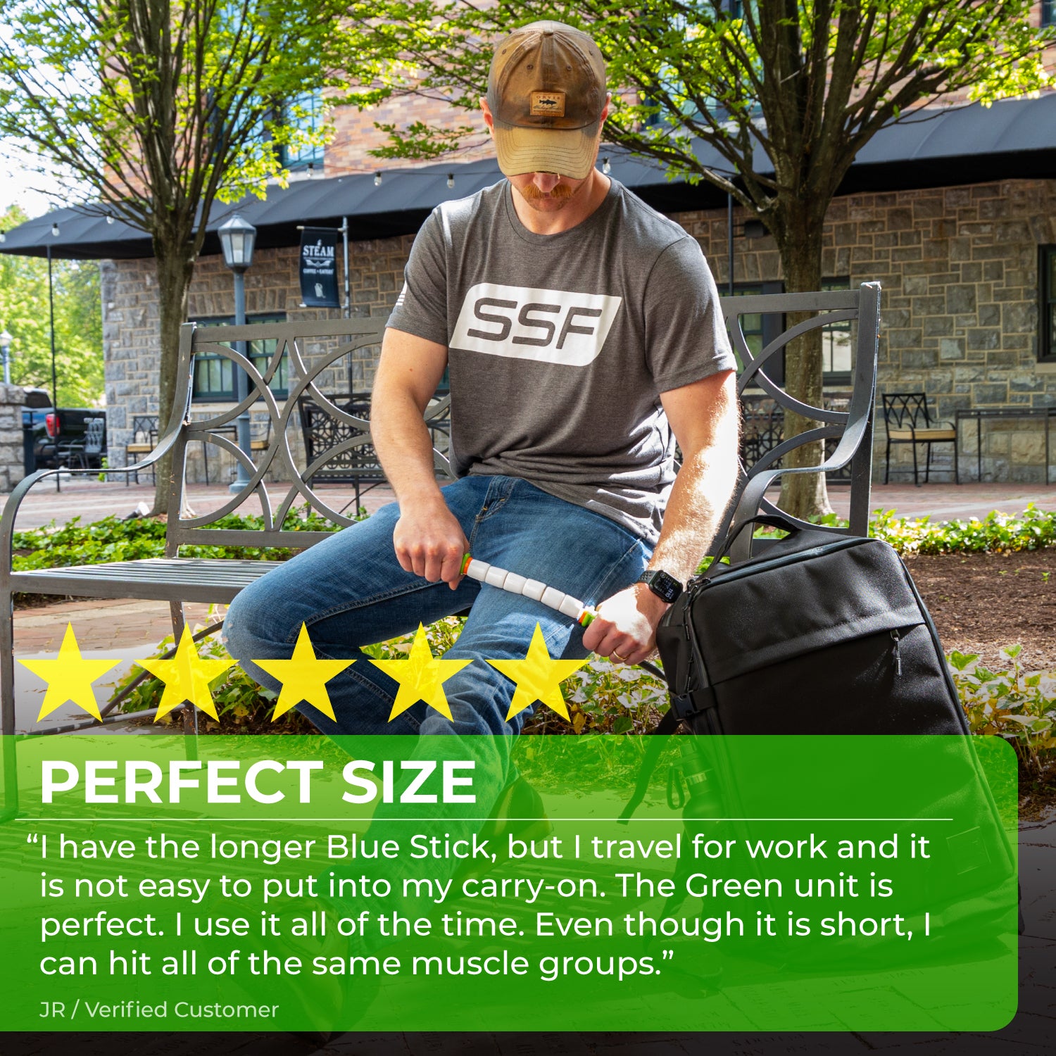 Wearing a cap and SSF shirt, a man sits on an outdoor bench using the Little Stick-14 massage stick. A black carry-on bag is beside him. Five yellow stars and a review praise its convenience and muscle recovery benefits.