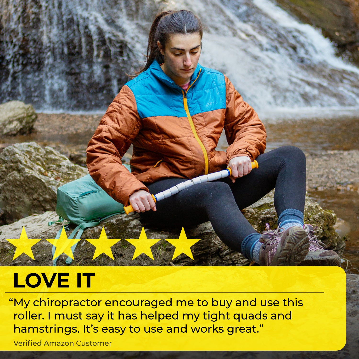 A woman in outdoor gear uses the Marathon Stick- 20 by a waterfall to massage her thigh for IT band relief. Five yellow stars and a highlighted customer review praising the rollers effectiveness appear at the image’s bottom.