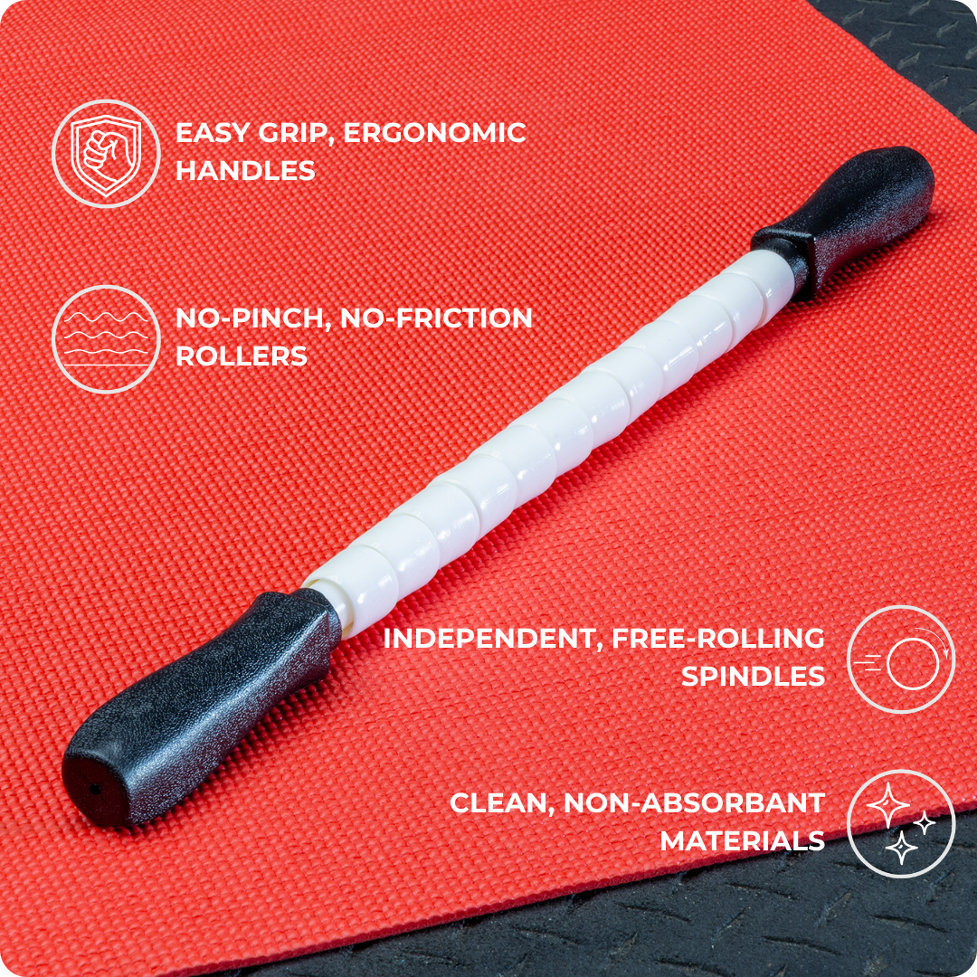 The Stiff Stick - 24 is a white deep tissue massage stick with black ergonomic handles, shown on a red textured mat. It features easy-grip handles, no-pinch rollers, free-rolling spindles, and clean, non-absorbent materials.