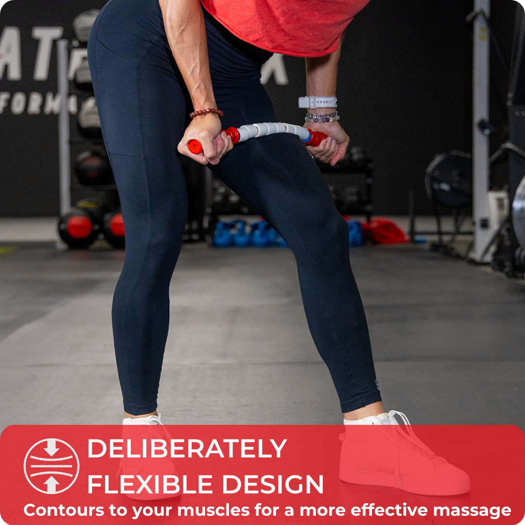 A person in athletic wear uses the Travel Stick- 18 on their thigh at the gym. Text overlay: Flexible design contours to muscles for an effective massage—making Travel Stick- 18 a true gym bag essential for muscle recovery.